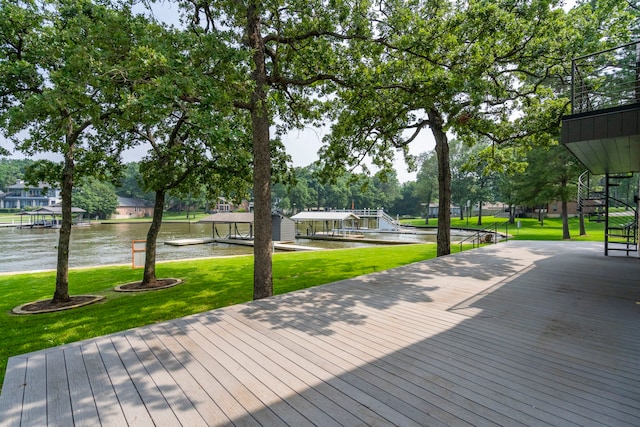 view of home's community with a water view and a yard