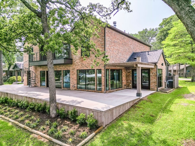 rear view of property with a patio and a lawn