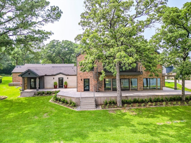 back of house with a wooden deck and a lawn