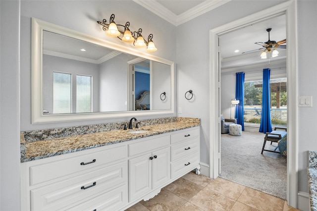 bathroom featuring tile patterned flooring, crown molding, vanity, and ceiling fan