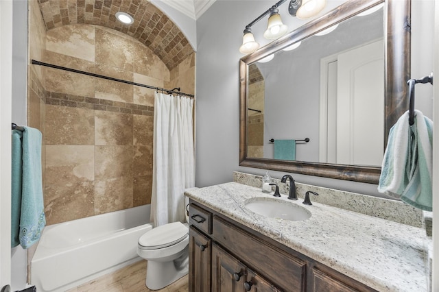 full bathroom featuring toilet, ornamental molding, vanity, and shower / bathtub combination with curtain