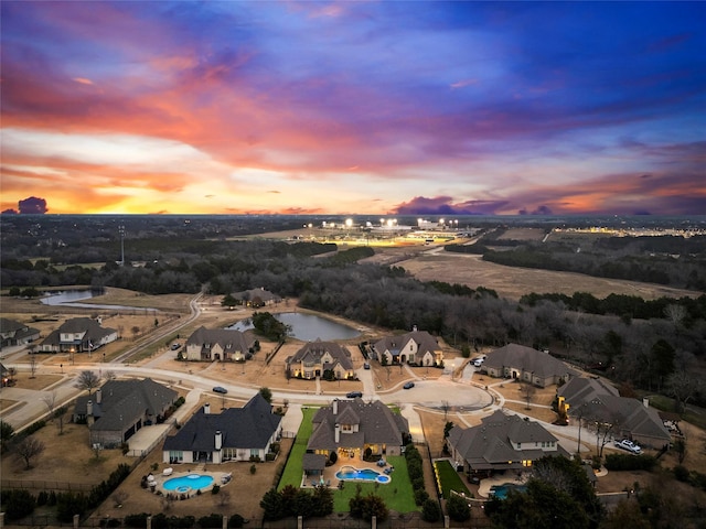 909 Reflection Ct, Heath, TX 75032 - aerial view at dusk of a water view, view of pool area, and a residential view