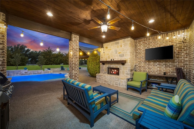 view of patio with an outdoor living space with a fireplace and ceiling fan