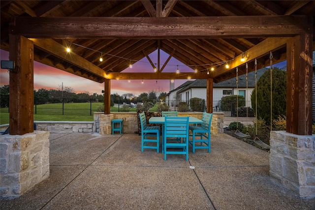 patio terrace at dusk with a gazebo and a lawn