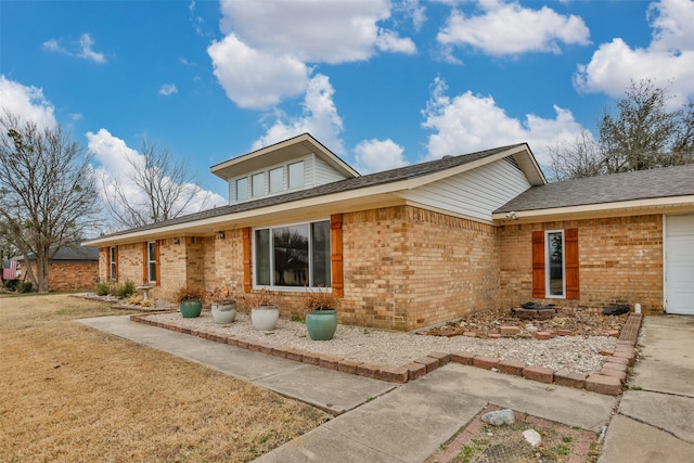 view of front of house with a garage and a front lawn