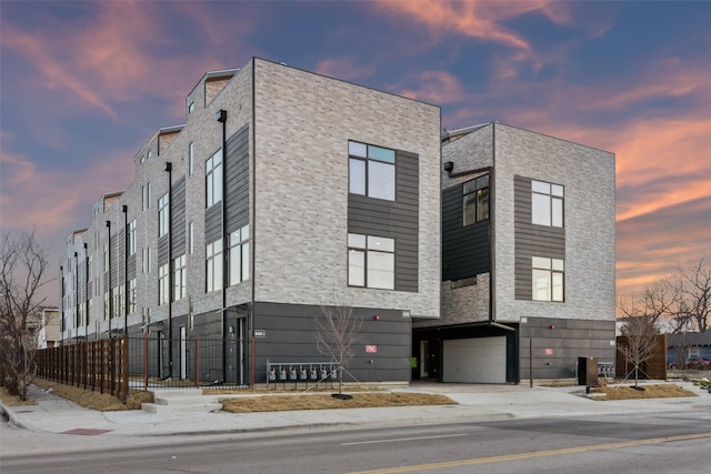 outdoor building at dusk with a garage