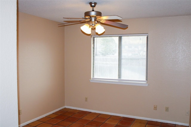 tiled empty room with ceiling fan