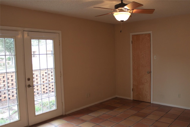 tiled empty room with french doors and ceiling fan