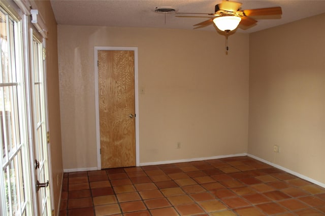 tiled empty room with ceiling fan