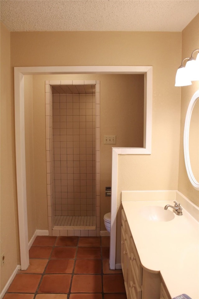 bathroom with tile patterned floors, toilet, a shower, a textured ceiling, and vanity