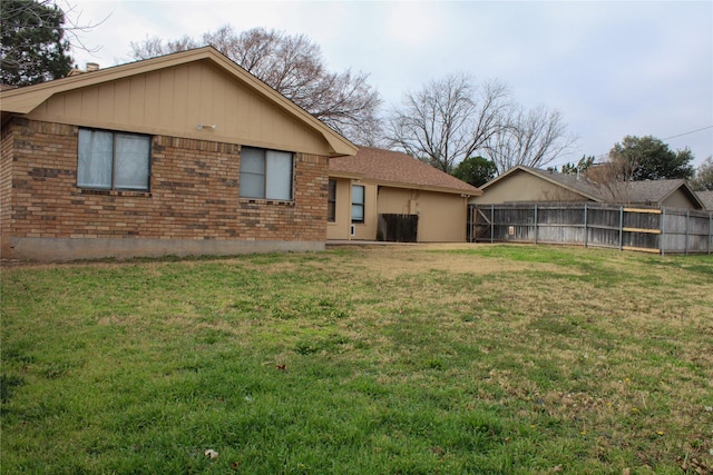 rear view of house with a yard