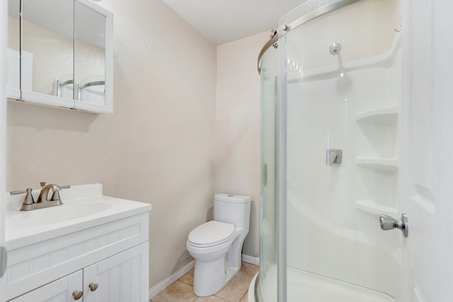 bathroom with vanity, tile patterned floors, toilet, and walk in shower