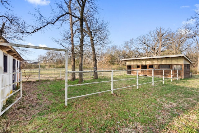 view of yard with an outdoor structure and a rural view