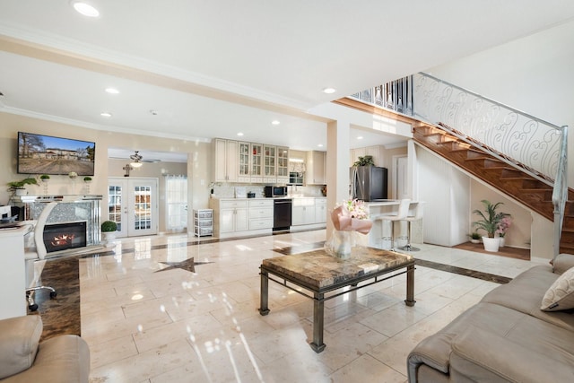 living room with french doors, ceiling fan, and crown molding