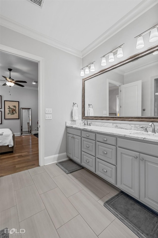 bathroom featuring crown molding, ceiling fan, vanity, and hardwood / wood-style floors