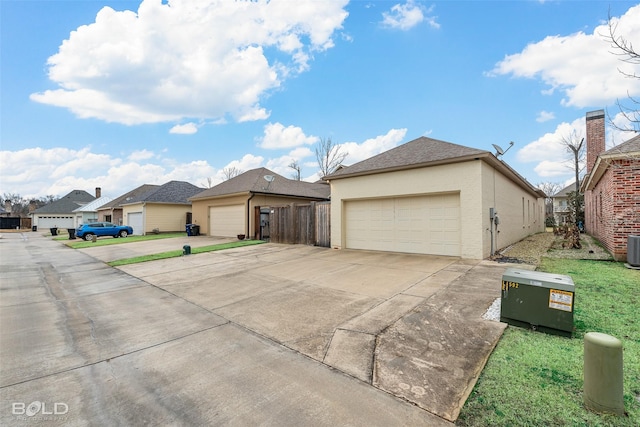 view of front of home featuring a garage and cooling unit