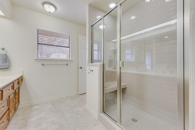 bathroom featuring vanity and a shower with shower door