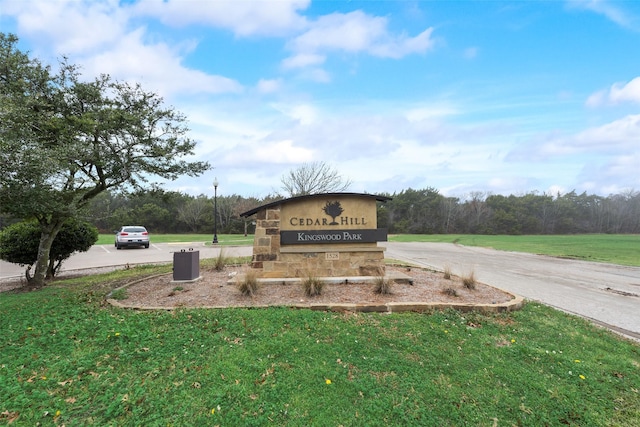 community / neighborhood sign with a lawn