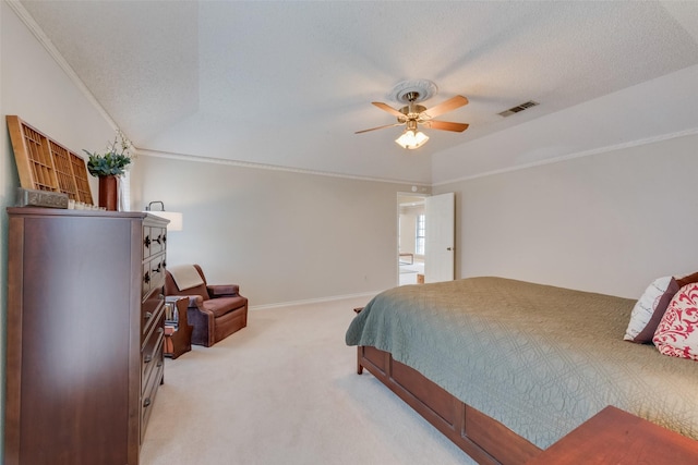 bedroom featuring crown molding, light colored carpet, and a textured ceiling