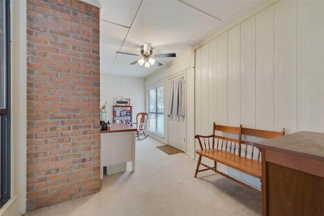 interior space with ceiling fan and light colored carpet