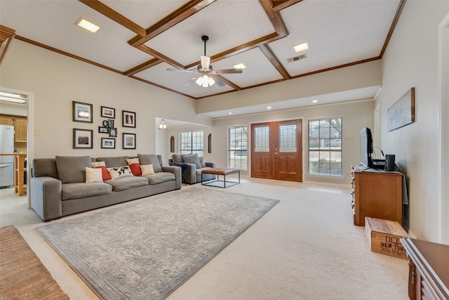 carpeted living room with ornamental molding and ceiling fan