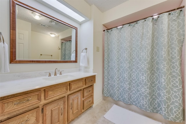 bathroom with vanity, a textured ceiling, and a shower with shower curtain