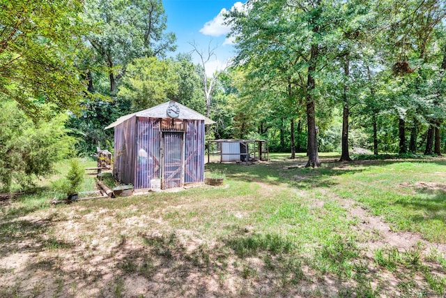 view of outdoor structure featuring a lawn