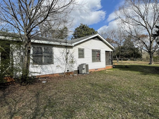 view of home's exterior with a yard and central AC