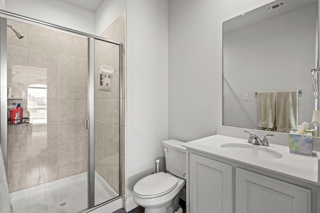 bathroom featuring vanity, toilet, and walk in shower