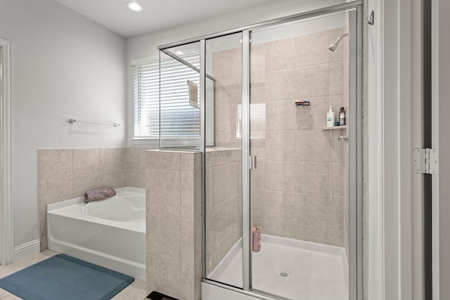 bathroom with separate shower and tub