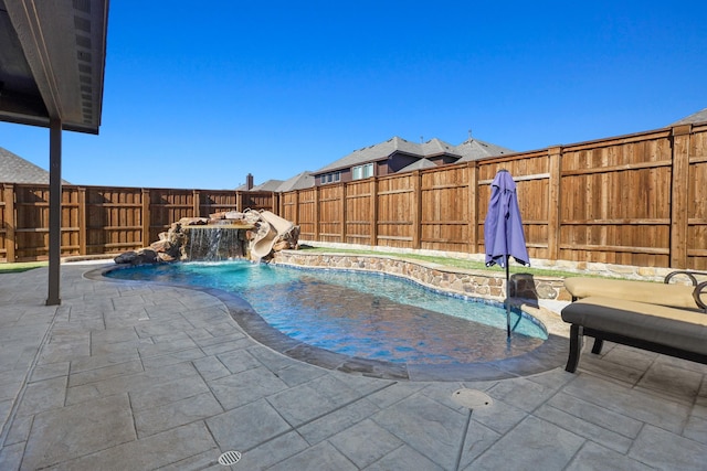 view of pool featuring pool water feature and a patio area