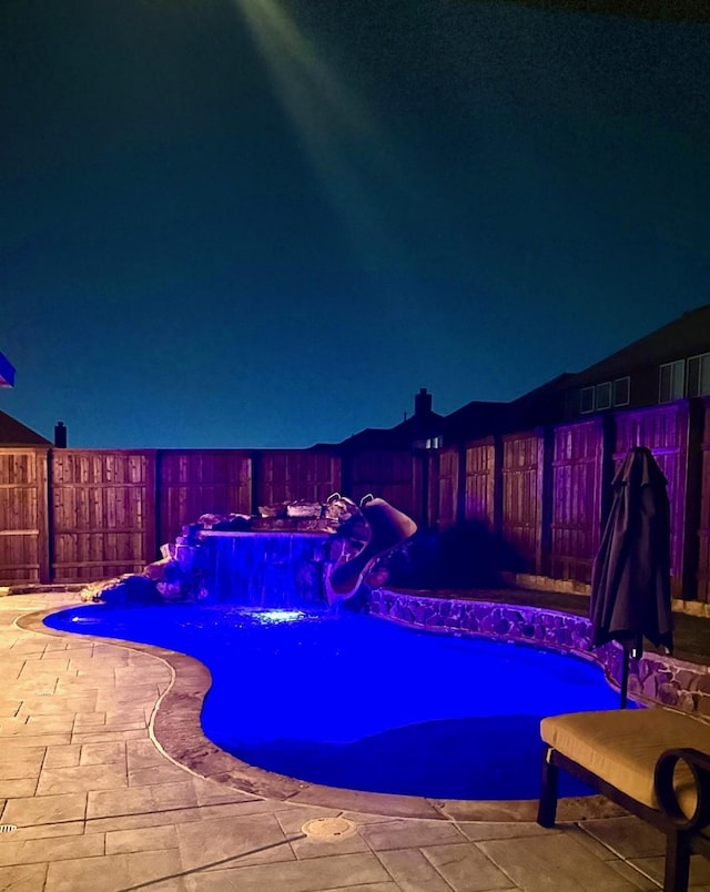 pool at twilight with a patio