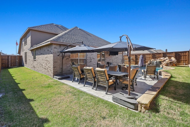 rear view of property with a patio area and a lawn