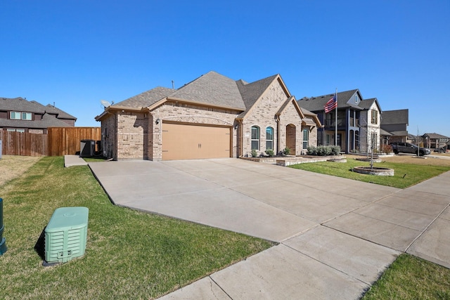 french country home featuring a garage and a front lawn