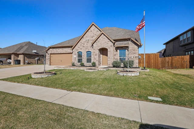 french country style house with a garage and a front yard