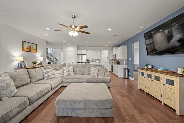 living room featuring dark hardwood / wood-style floors and ceiling fan