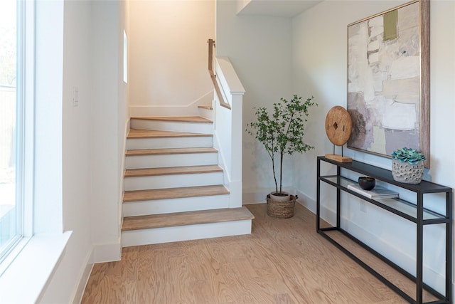 stairs with hardwood / wood-style flooring