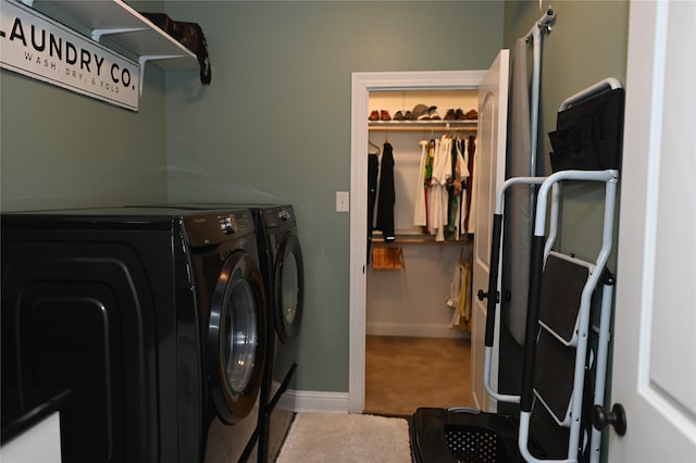 clothes washing area with carpet flooring and washer and dryer