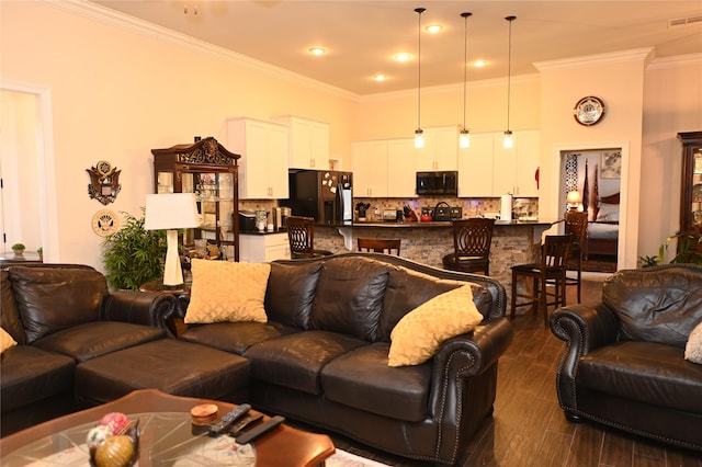 living room with ornamental molding and dark hardwood / wood-style floors