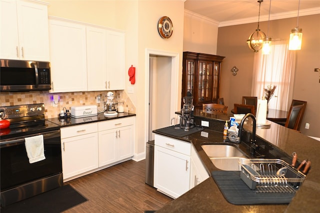 kitchen featuring sink, white cabinets, hanging light fixtures, ornamental molding, and stainless steel appliances