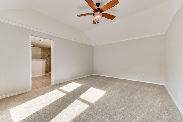 unfurnished bedroom with vaulted ceiling, light carpet, ceiling fan, and crown molding