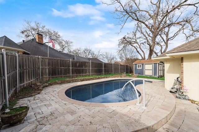 view of pool with a storage shed and a patio