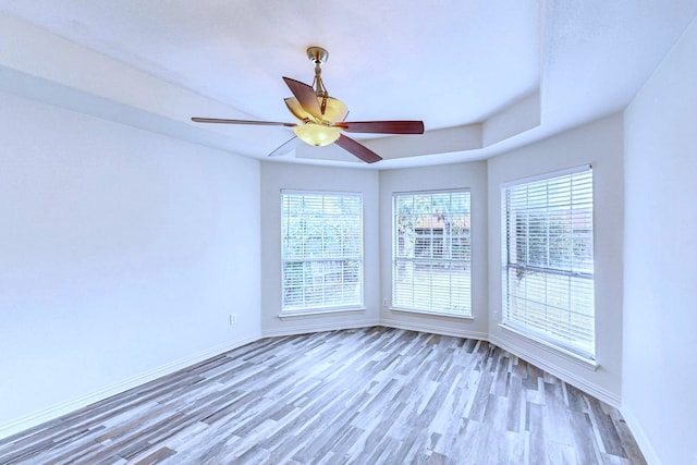 unfurnished room featuring hardwood / wood-style floors and ceiling fan