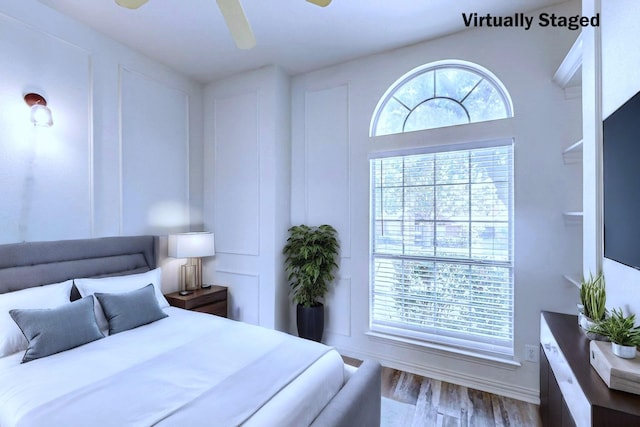 bedroom featuring multiple windows, ceiling fan, and light hardwood / wood-style flooring