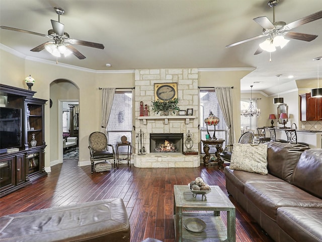 living room featuring crown molding, a fireplace, and dark hardwood / wood-style floors