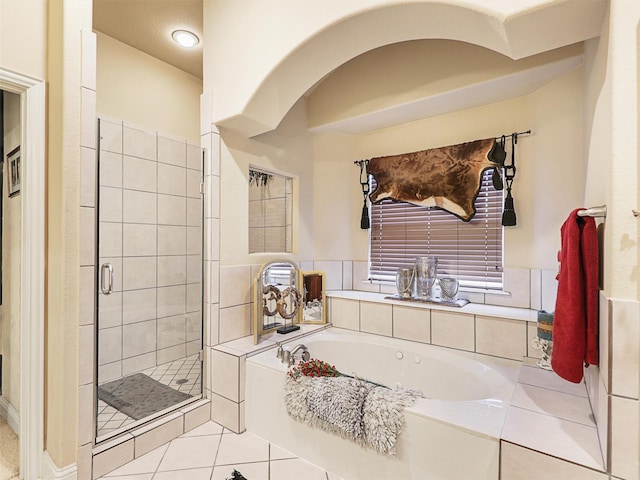 bathroom with tile patterned flooring and independent shower and bath