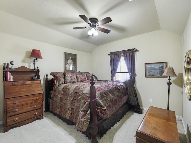 bedroom with ceiling fan, light colored carpet, and lofted ceiling