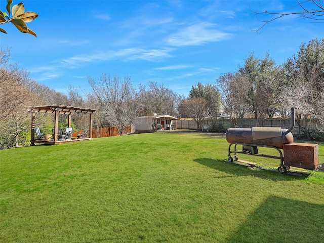 view of yard featuring an outbuilding and a pergola