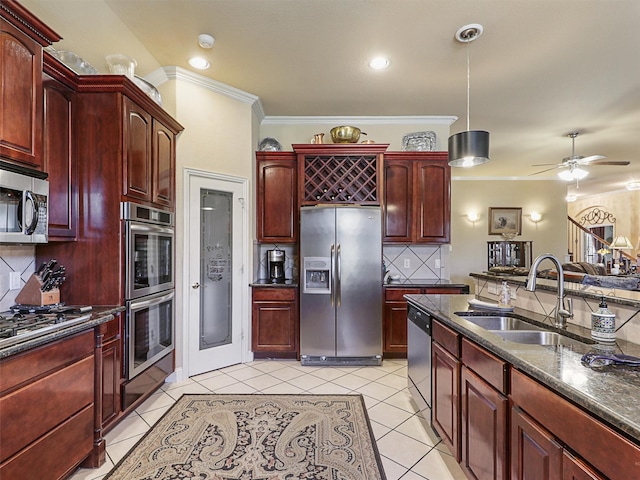 kitchen featuring sink, light tile patterned floors, backsplash, stainless steel appliances, and decorative light fixtures