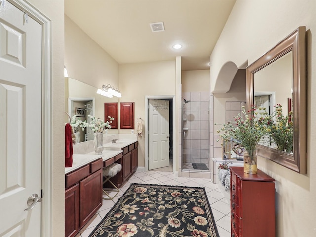 bathroom featuring vanity, a shower with shower door, and tile patterned flooring